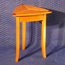 Triangular table of mixed woods